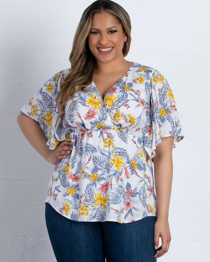Front of a model wearing a size 0X Seaside Serenade Top in WHITE TROPICAL BLOOMS by Kiyonna. | dia_product_style_image_id:227533